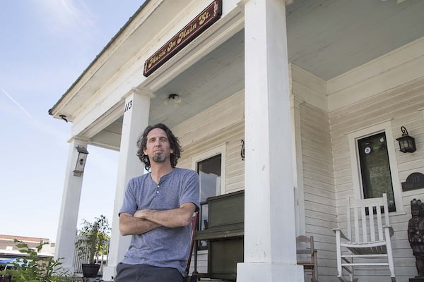 Scott Mecredy, owner of Music on Main Street, poses for a photo outside the business in downtown Lilburn. He was amazed so many parents were willing to try a new way to have their kids stick with music lessons and were anxious to help keep the business afloat. (ALYSSA POINTER / ALYSSA.POINTER@AJC.COM)