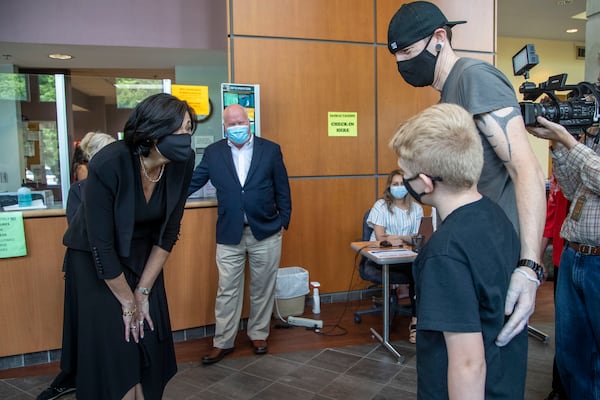 In this May 2021, file photo Dr. Rochelle Walensky, left, Director of the Centers for Disease Control and Prevention, greets 12-year-old Larry Hall while visiting the Whitfield County Health Department in Dalton. (Alyssa Pointer / Alyssa.Pointer@ajc.com)