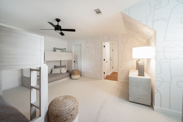 When family or friends stay over, younger visitors sleep in this serene bunk room, which Rachel Nelson wanted to be fun for younger ages, but not too juvenile. Understated Restoration Hardware Baby and Child bunk beds and a CB2 dresser lend the room a sense of calm. As a finishing touch, the playful Lulu and Georgia pillows mirror the muted Murals wallpaper. Text by Lori Keong/Photo by Amanda Winchester