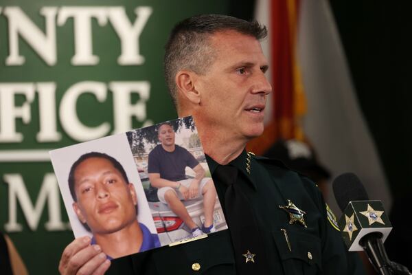 In this file photo, Sheriff John W. Mina shows photos of Armando Manuel Caballero during a news conference in the case of 19-year-old Miya Marcano. Caballero had been named a person of interest in the case and was found dead in an apartment complex in Seminole County, Florida. (Ricardo Ramirez Buxeda/Orlando Sentinel/TNS)