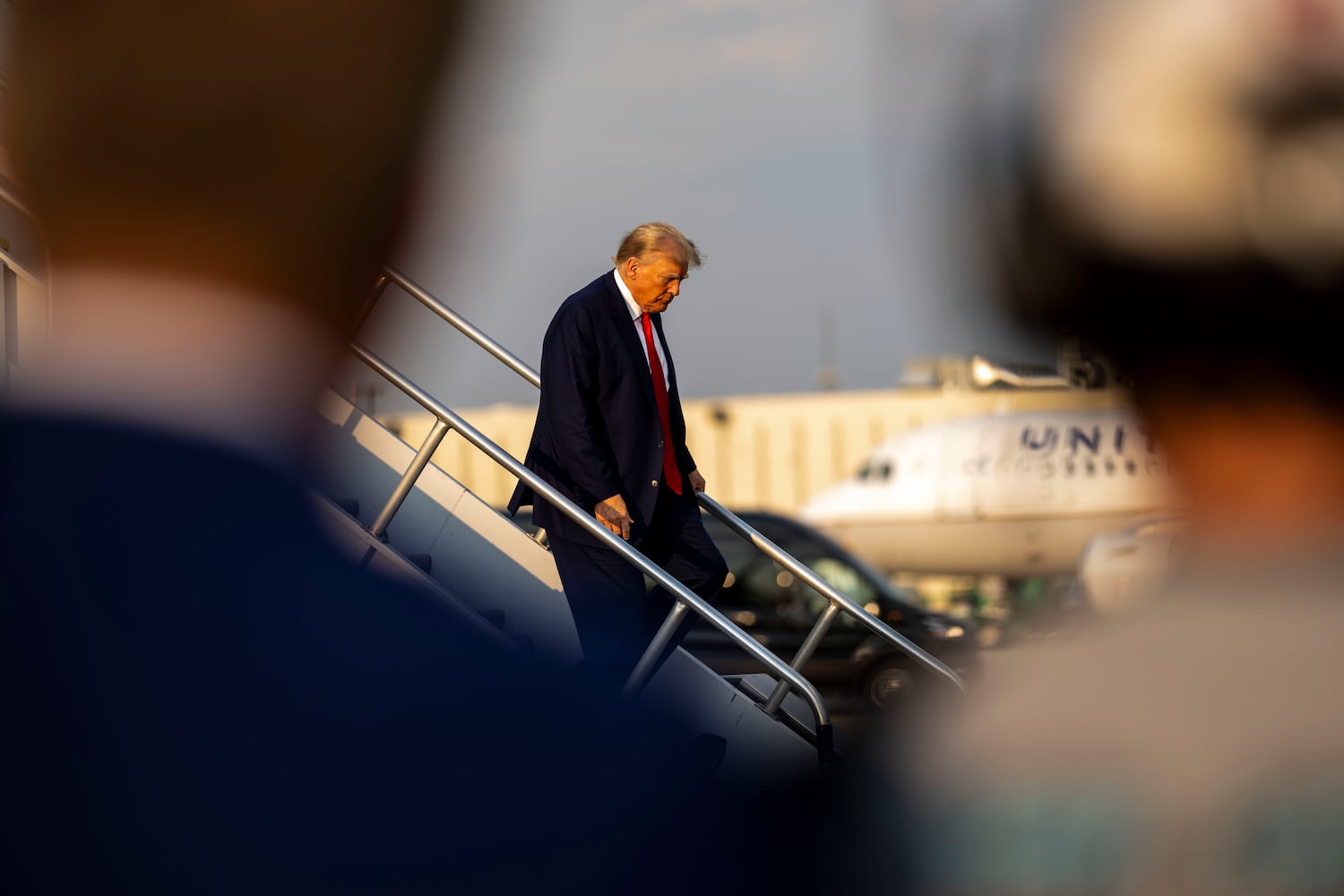 Donald Trump exits his private plane after arriving at Hartsfield-Jackson International Airport in Atlanta on Thursday, Aug. 24, 2023, where he was expected to turn himself in at the Fulton County Jail later in the evening. (Doug Mills/The New York Times)