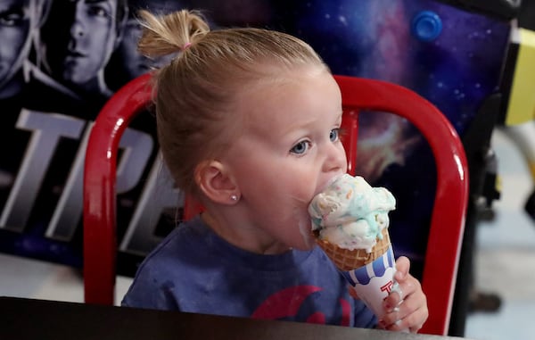 Emilie Winkles takes a bite from her cone of birthday cake ice cream at Happy Days Ice Cream Parlor in Guyton.