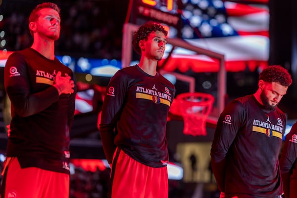 Atlanta Hawks forward Zaccharie Risacher (10) stands for the National Anthem before the Emirates NBA Cup basketball game between the Cleveland Cavilers and the Atlanta Hawks on Friday, Nov. 29, 2024, in Atlanta. (AP Photo/Erik Rank)