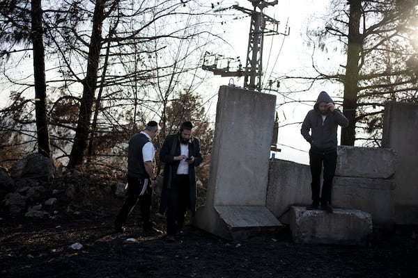 Ultra-Orthodox Jewish men tour northern Israel, near the border with Lebanon, during a ceasefire, Tuesday, Dec. 3, 2024. (AP Photo/Maya Alleruzzo)