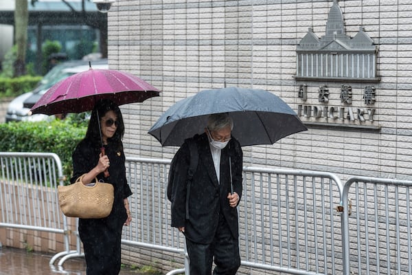 Jimmy Lai's wife Teresa Lai, left, and retired Chinese cardinal Joseph Zen Ze-Kiun arrive at West Kowloon Magistrates' Courts to attend Hong Kong activist publisher Lai's national security trial in Hong Kong, Wednesday, Nov. 20, 2024. (AP Photo/Chan Long Hei)