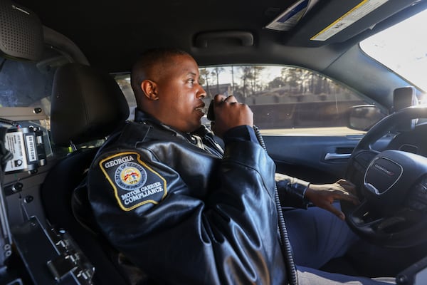 Georgia Department of Public Safety Officer Terrell Truitt calls in before he pulls over a commercial truck on I-20 in DeKalb County.