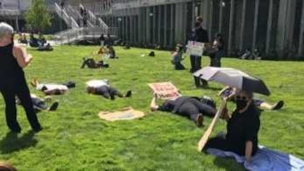 At least two dozen people gathered at Georgia State University's Atlanta campus on Sept. 9, 2021 for a "die-in" demonstration for additional safety measures to mitigate the spread of COVID-19 at the school. PHOTO CREDIT: United Campus Workers of Georgia.