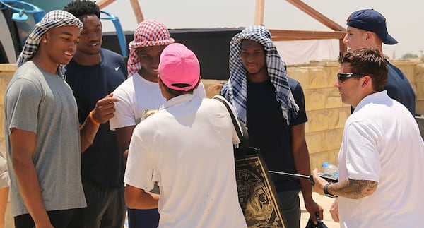 Okogie (navy shirt, blue and white headdress) tried his hand at bartering during his team's visit to the Pyramids of Giza outside Cairo.