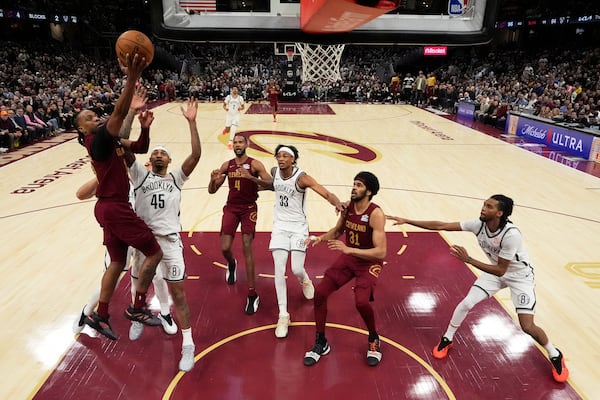 Cleveland Cavaliers guard Darius Garland (10), left, shoots in the second half of an NBA basketball game against the Brooklyn Nets, Tuesday, March 11, 2025, in Cleveland. (AP Photo/Sue Ogrocki)