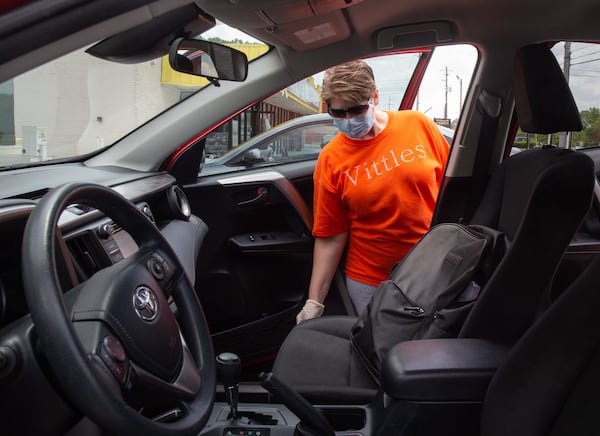 Vittles Restaurant owner Charity Salyers looks over her new 2017 Toyota Rav 4 outside her Smyrna restaurant Thursday, May 14, 2020. STEVE SCHAEFER FOR THE ATLANTA JOURNAL-CONSTITUTION