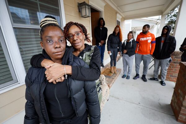 Tonya McElrathbey embraces her daughter Brittany during a family reunion as Brittany's siblings gather around. McElrathbey family members said they were on their own when Brittany was shot in January and family members calling 911 were put on hold.  Miguel Martinez/miguel.martinezjimenez@ajc.com