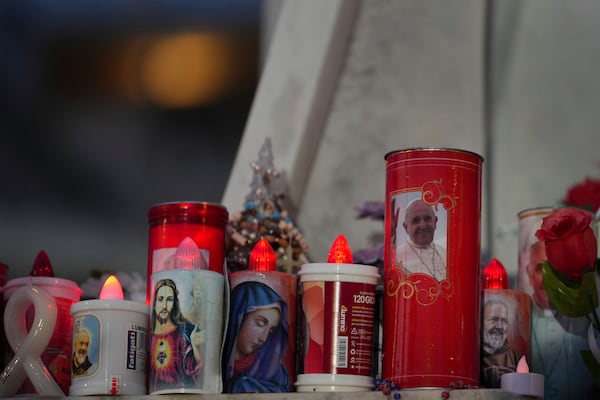 Candles are lit up for Pope Francis in front of the Agostino Gemelli Polyclinic, where the Pontiff has been hospitalized since Feb. 14, in Rome, Wednesday, Feb. 26, 2025. (AP Photo/Kirsty Wigglesworth)