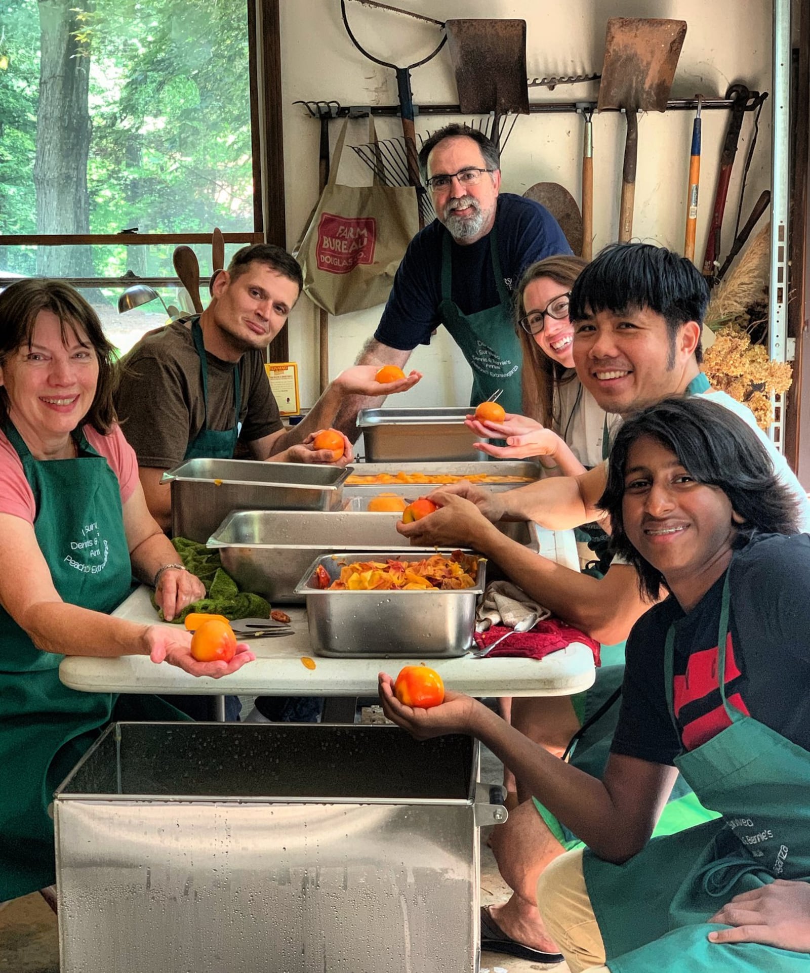 The kitchen crew pauses during a peach-canning session at the home of Bernie Wong in Carrollton, Georgia. “Every year, nine families in this Georgia town pool their resources to buy 750 pounds of the freshest peaches,” writes Asha Gomez. “For an entire week, one of their homes becomes a production facility, resulting in peach jam, peach barbecue sauce, peach chutney, peach pie filling and peach preserves.” CONTRIBUTED BY ASHA GOMEZ