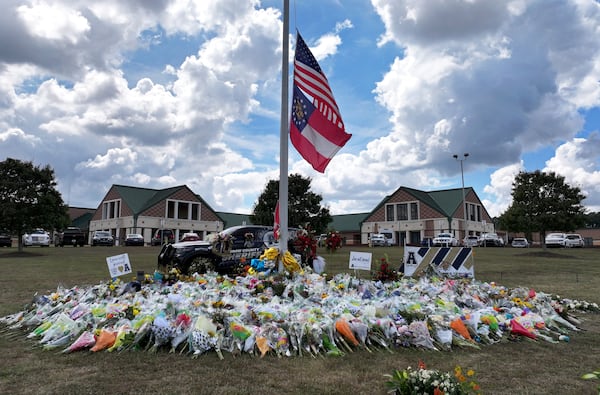 Photo shows a makeshift memorial at Apalachee High School, Thursday, September 19, 2024, in Winder. Students at Apalachee High School outside Atlanta will return to campus for half-days beginning next week, Barrow County school officials announced, after a Sept. 4 shooting that killed four people and injured nine others. (Hyosub Shin / AJC)