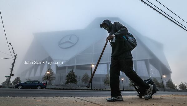 Nathaniel Howard makes his way along Northside Drive past Mercedes-Benz Stadium. 