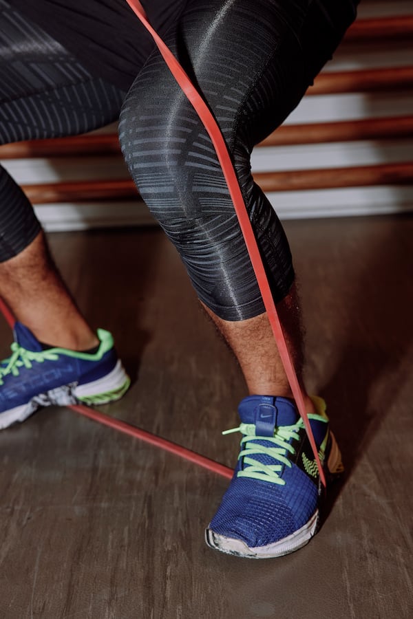 Serigo Almaraz demonstrates an exercise that uses resistance bands. (Jared Soares/The New York Times)