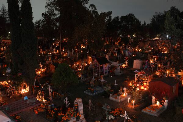 Families gather to keep company with their dearly departed, celebrating Day of the Dead at the San Gregorio Atlapulco cemetery, on the outskirts of Mexico City, Saturday, Nov. 2, 2024. (AP Photo/Moises Castillo)