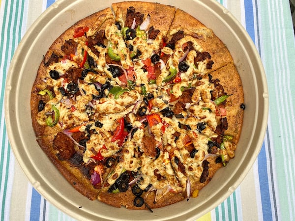 The Off Da Wall vegan pizza from Plant-Based Pizzeria & More is chock-full of veggies. Pictured is a gluten-free version made with a cauliflower crust. Ligaya Figueras/ligaya.figueras@ajc.com
