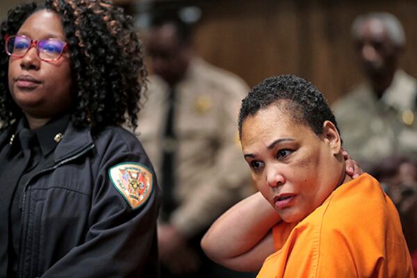 Sherra Wright listens as prosecutor Paul Hagerman reads a list of evidence against her during a July 25 court hearing in the death of former Hawks player Lorenzen Wright.