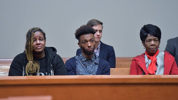 Christopher Williams’ family members (from left) niece Arriyana Williams, nephew Xavier Williams and mother Cathy White react during a hearing  before Superior Court Judge Asha F. Jackson at DeKalb County Superior Court in Decatur on Thursday.