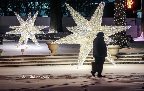 Keisha Palmer is bundled up at 15th and Peachtree Street on a snowy Wednesday. JOHN SPINK / JSPINK@AJC.COM