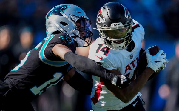 Falcons receiver Russell Gage is tackled by Panthers cornerback C.J. Henderson during the first half of Sunday's game. (AP Photo/Jacob Kupferman)