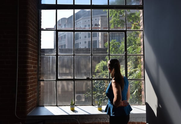 In this 2017 AJC file photo, Police Alternatives and Diversion Executive Director Moki Macias looks out on the Atlanta City Detention Center from her offices. PAD provides services and resources to people who might otherwise be arrested on non-violent charges, and trains police officers to divert some arrests. HYOSUB SHIN / HSHIN@AJC.COM