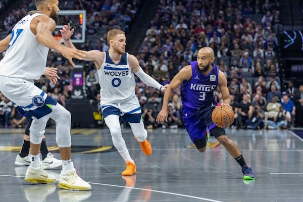 Sacramento Kings guard Jordan McLaughlin (3) drives to the basket with Minnesota Timberwolves guard Donte DiVincenzo (0) defending during the first half of an Emirates NBA Cup basketball game Friday, Nov. 15, 2024, in Sacramento, Calif. (AP Photo/Sara Nevis)