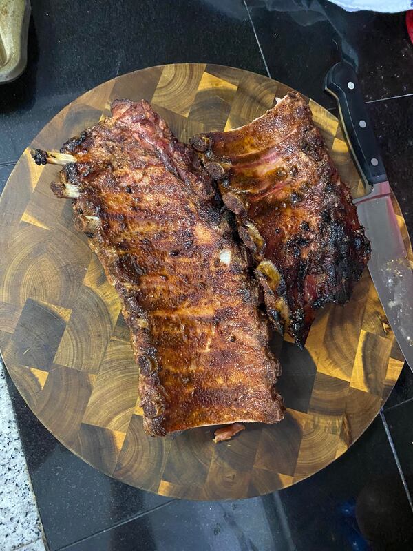 Coleman and Carson Raymond let ribs sit for a few minutes after being pulled off the grill. Courtesy of Carson Raymond