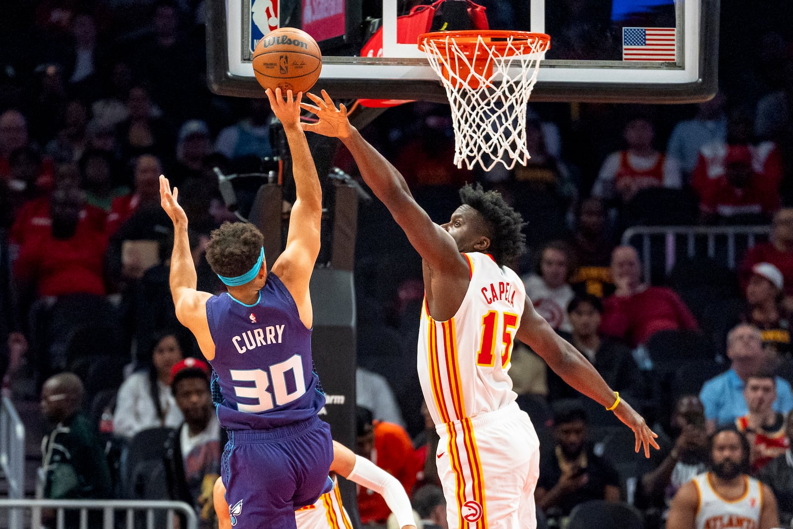 Atlanta Hawks center Clint Capela (15) blocks a shot by Charlotte Hornets guard Seth Curry (30) during the first half of an NBA basketball game, Friday, Oct. 25, 2024, in Atlanta. (AP Photo/Jason Allen)