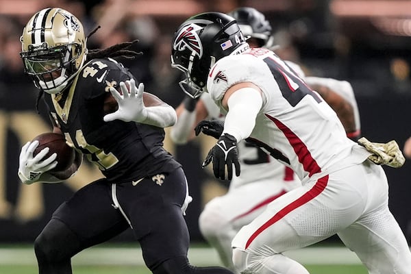 New Orleans Saints running back Alvin Kamara (41) runs against Atlanta Falcons linebacker Troy Andersen (44) during the second half of an NFL football game, Sunday, Nov. 10, 2024, in New Orleans. (AP Photo/Gerald Herbert)