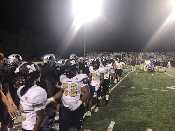 Starr's Mill and Newnan players share handshakes after Starr's Mill's 28-14 win on Aug. 21, 2021 in the Fayette-Coweta Kickoff Classic.