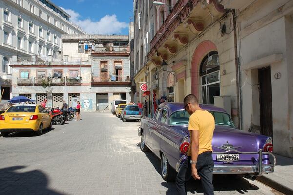 A street scene in Old Havana illustrates how renovated buildings sit side-by-side with crumbling facades. PHOTO CREDIT: Bill Osinski