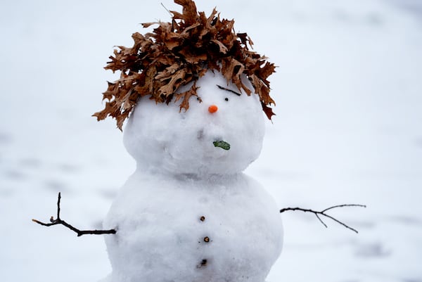 A snowman with leaves for hair sits in a park Thursday, Jan. 9, 2025, in Richardson, Texas. (AP Photo/LM Otero)