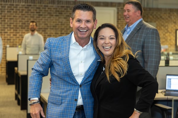 Pat Flood poses with potential associate Courtney Thomas 
at Supreme Lending in Alpharetta for the Top Workplace medium sized business. PHIL SKINNER FOR THE ATLANTA JOURNAL-CONSTITUTION