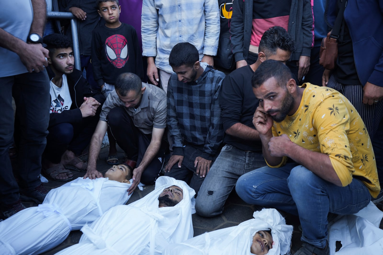 Palestinians mourn their relatives killed in the Israeli bombardment of the Gaza Strip at a hospital morgue in Deir al-Balah, Tuesday, Oct. 29, 2024. (AP Photo/Abdel Kareem Hana)