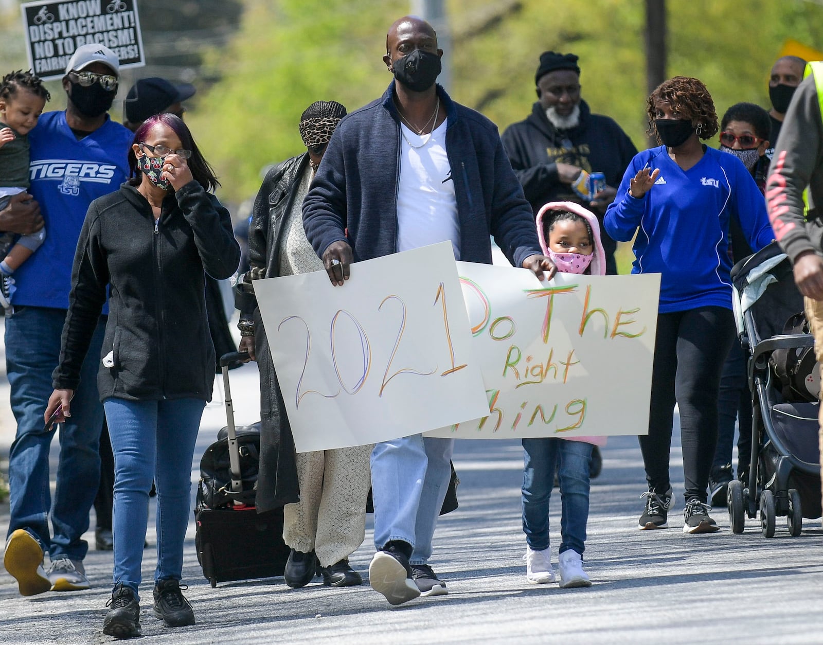 Douglasville residents Huntia Perryman (from left), her husband, Dennis, and their granddaughter Jourdan Belton march to the site of the former Chattahoochee Brick Company during a sacred event to commemorate the lives lost during a period the company used the convict lease system. The event included a procession, prayers, libations, community testimonials, and site consecration Saturday, April 3, 2021, in Atlanta. (Photo: Daniel Varnado for The Atlanta Journal-Constitution)