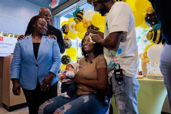 Deandre Phillips wipes the brow of Alandria Worthy during the baby shower for their daughter.