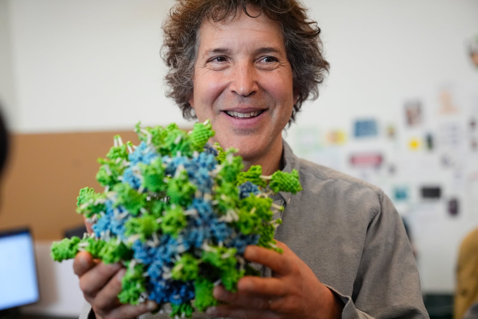 American biochemist David Baker, 2024 Nobel Prize winner in Chemistry, holds a model of a designed protein nanoparticle during a tour at the University of Washington on Wednesday, Oct. 9, 2024, in Seattle. (AP Photo/Lindsey Wasson)