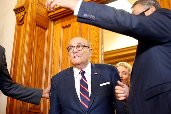 Rudy Giuliani walks to a senate hearing at the Georgia State Capitol in Atlanta on Thursday, December 3, 2020. The Georgia Senate Committee on Judiciary has formed a special subcommittee to take testimony of elections improprieties and evaluate the election process. (Rebecca Wright for the Atlanta Journal-Constitution)