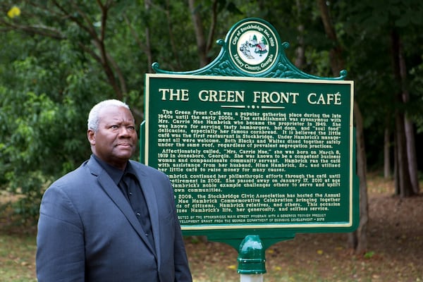 Stockbridge City Councilman Alphonso Thomas poses for a portrait next to a historical marker for The Green Front Cafe. (Casey Sykes for The Atlanta Journal-Constitution)