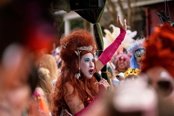 A woman sings during the Society of Saint Anne's parade on Mardi Gras Day, Tuesday, March 4, 2025 in New Orleans. (AP Photo/Gerald Herbert)