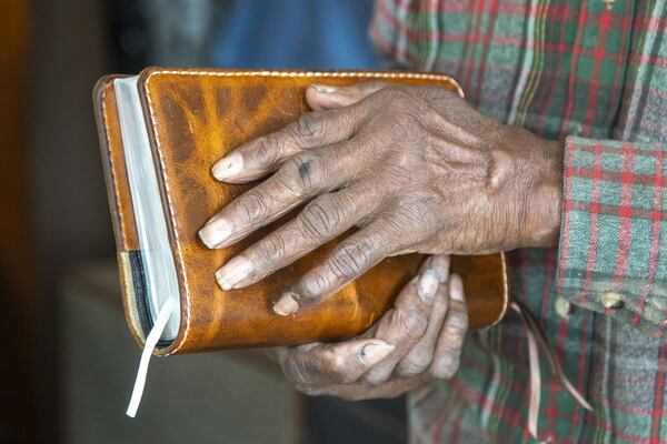 Joe Jordan, 82, owner of Cato Shoe Repair, shows off a leather cover that he fitted for a customer’s Bible at his store in Atlanta. In addition to shoes, Joe and his wife, Hattie, work on belts, purses, luggage and more. (ALYSSA POINTER / ALYSSA.POINTER@AJC.COM)