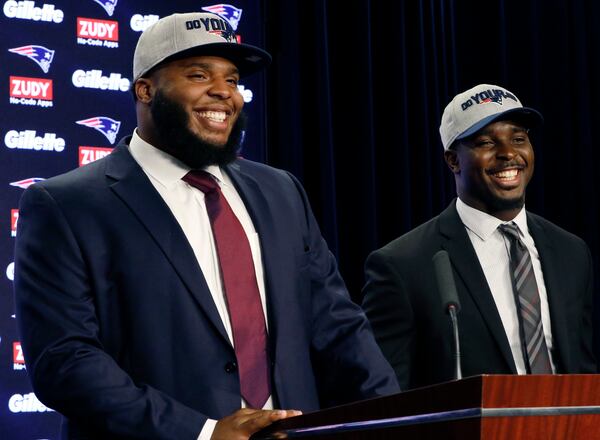 New England Patriots first-round NFL draft picks, offensive lineman Isaiah Wynn, left, and running back Sony Michel, both out of the University of Georgia, laugh during a media availability, Friday, April 27, 2018, in Foxborough, Mass. (AP Photo/Bill Sikes)