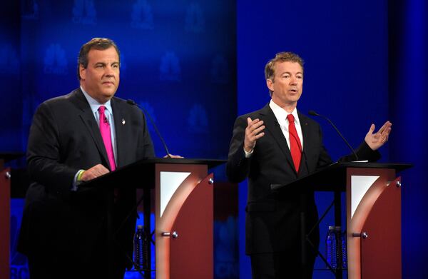 Rand Paul, right, speaks as Chris Christie looks on during the CNBC Republican presidential debate at the University of Colorado, Wednesday, Oct. 28, 2015, in Boulder, Colo. (AP Photo/Mark J. Terrill)