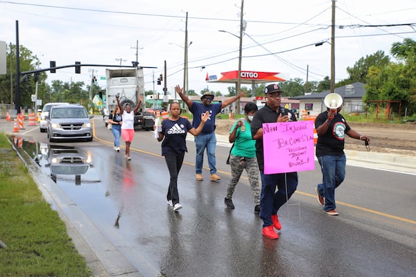 Rev. Dwight Futch (Left) and Alan Mainor leading community members on their march for Saudi Aria Lee to city hall on Saturday, July 16, 2022