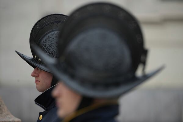 Pontifical Swiss Guards patrol during a mass for the jubilar pilgrims from Naples wait for the start of the celebration on a rainy day in St. Peter's Square at The Vatican, Saturday, March 22, 2025, while Pope Francis is being treated for bilateral pneumonia at Rome's Agostino Gemelli Polyclinic since Feb. 14. (AP Photo/Andrew Medichini)