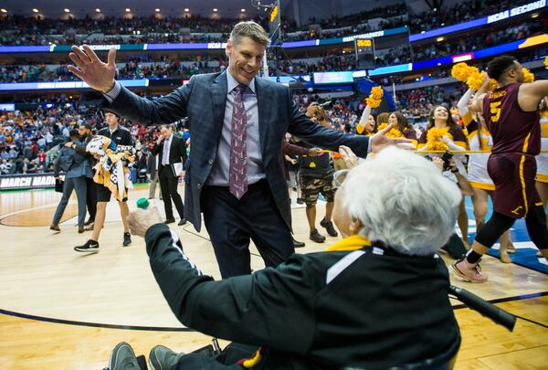 Loyola head coach Porter Moser hugs Sister Jean Dolores-Schmidt, chaplain for the Ramblers, after a 63-62 win against Tennessee in the second round of the NCAA Tournament on Saturday, March 17, 2018, at American Airlines Center in Dallas. (Ashley Landis/Dallas Morning News/TNS)