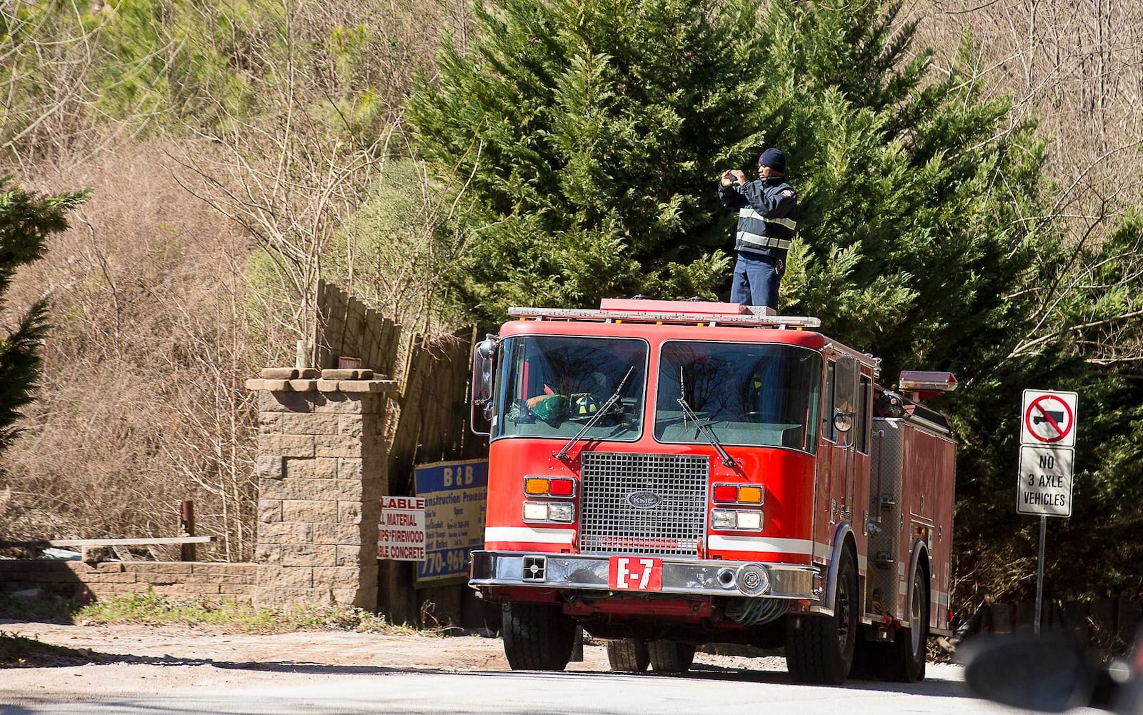 A member of the South Fulton Fire Department takes photos of an unlicensed landfill, located at 7635 Bishop Road, in South Fulton, Wednesday, Feb. 13, 2019. (ALYSSA POINTER/ALYSSA.POINTER@AJC.COM)