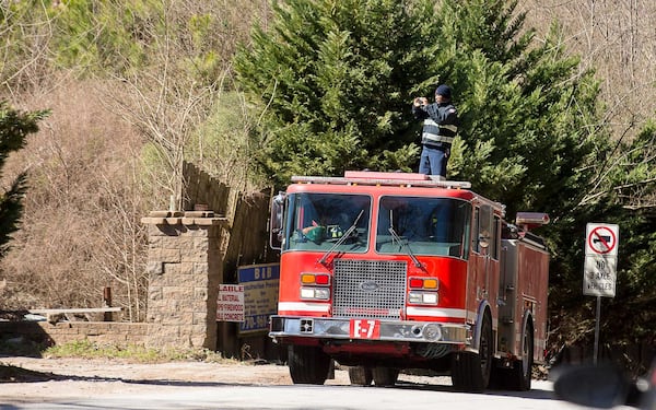 A member of the South Fulton Fire Department takes photos of an unlicensed landfill, located at 7635 Bishop Road, in South Fulton, Wednesday, Feb. 13, 2019. (ALYSSA POINTER/ALYSSA.POINTER@AJC.COM)